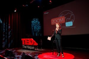 ACCESS Stories June 2026. Reinventing Yourself Abroad. Ana Denis giving a speech at TEDx The Hague