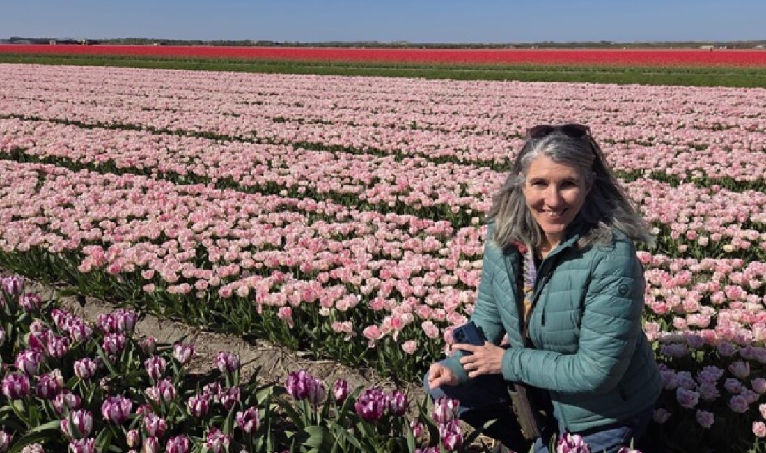 ACCESS Stories - November 2026. Full Circle Relocation Story. Kristin Anderson in a tulip field.